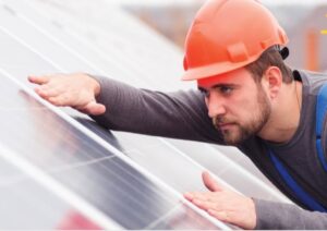 man fitting solar power panel