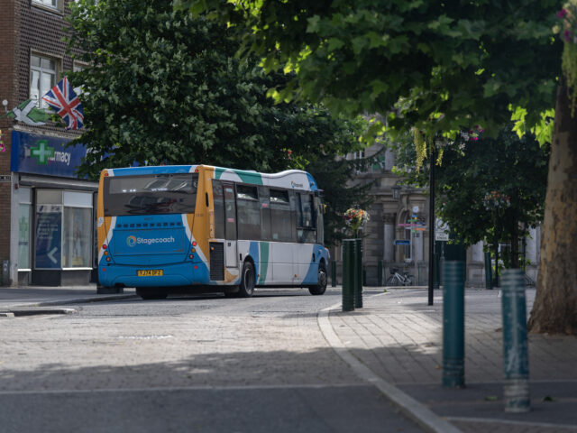 Stagecoach bus driving away on high street